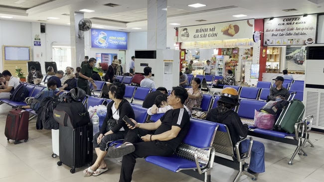 Passengers waiting for a train at Huong Pho Railway Station